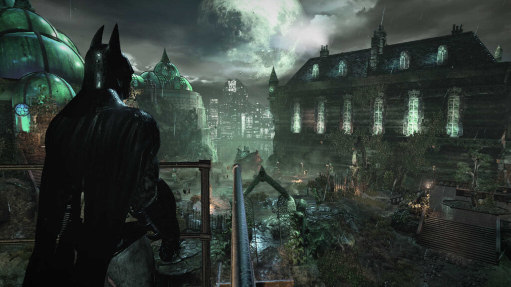 Batman oteando en la oscuridad por encima de los edificios en el videojuego Batman: Arkham Asylum